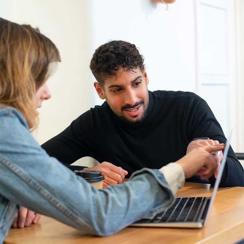 Man-and-woman-looking-at-laptop-together